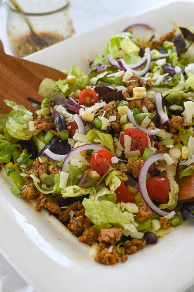 tossed chicken taco salad in white bowl