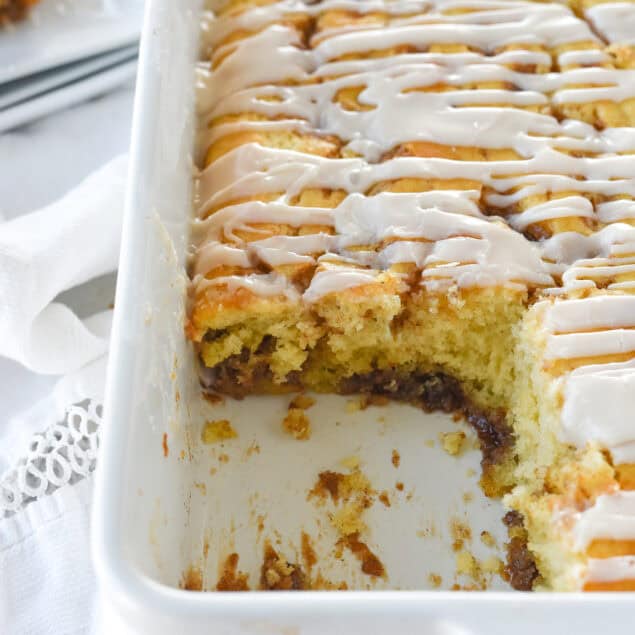 pan of cinnamon roll cake with piece missing
