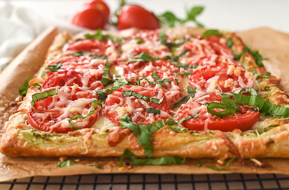 fresh tomato tart slices of tomato tart on brown paper