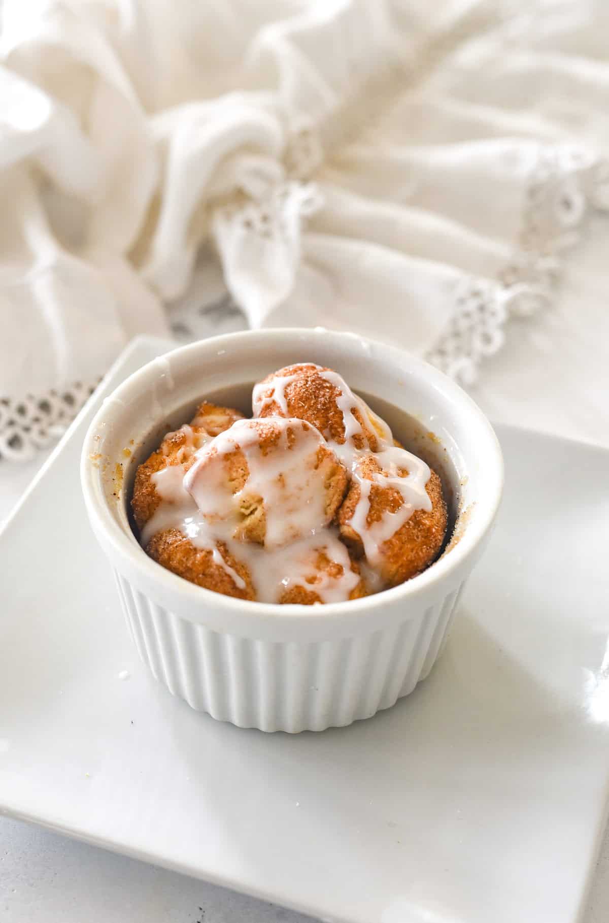 an individual monkey bread for one with glaze on top.