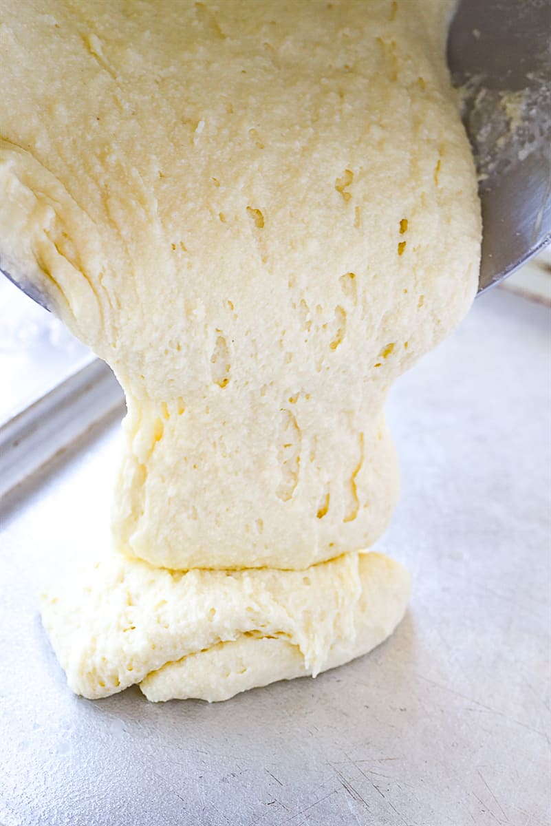 pouring lemon sheet cake batter into pan.