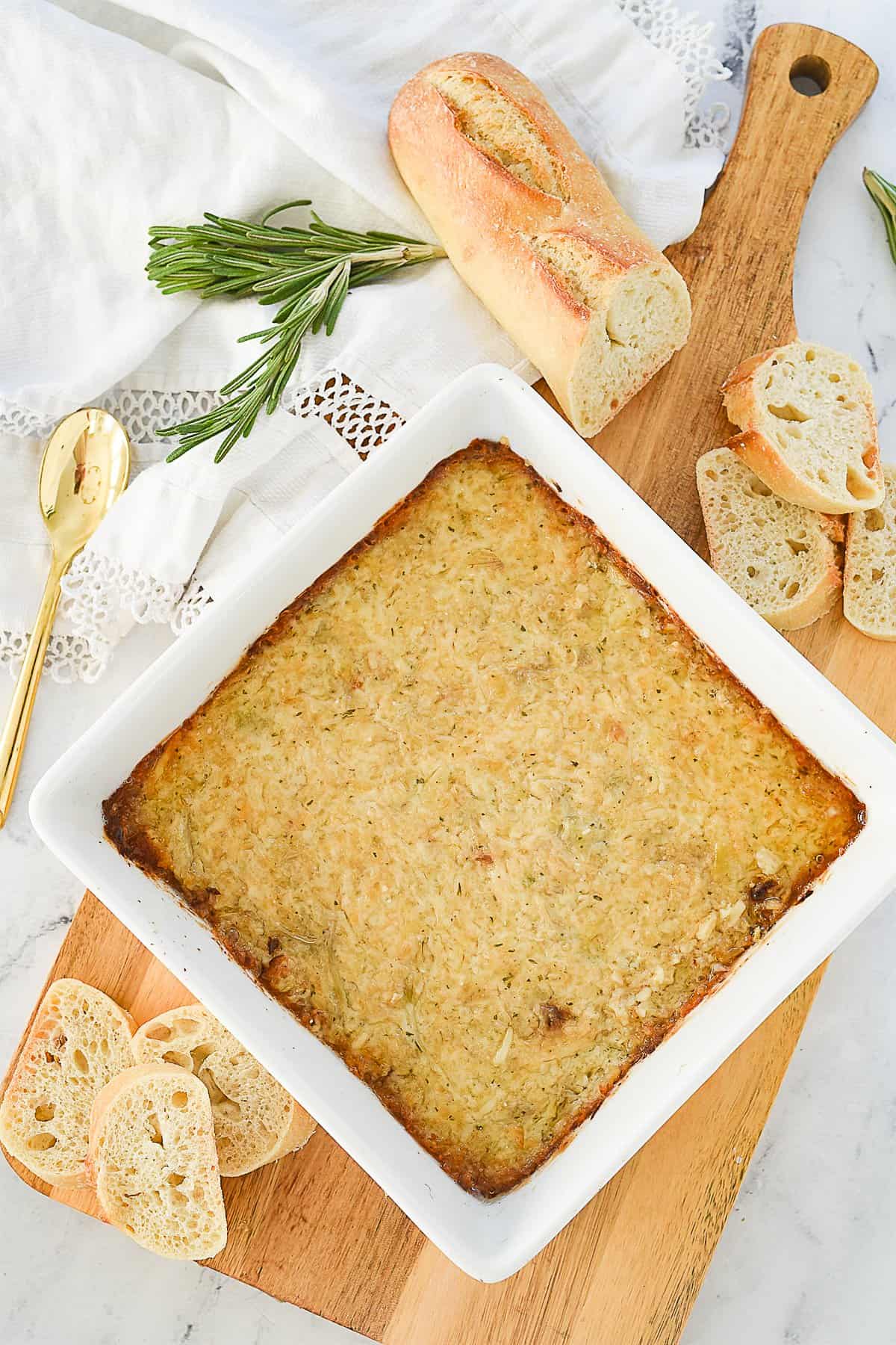 overhead shot of garlic artichoke dip in a white dish